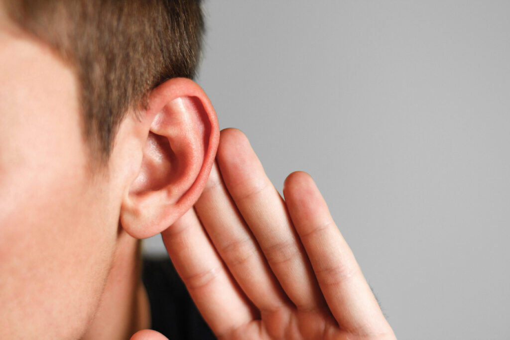 Close up of a male patient showing us his ear after getting  Ear Shaping Surgery.